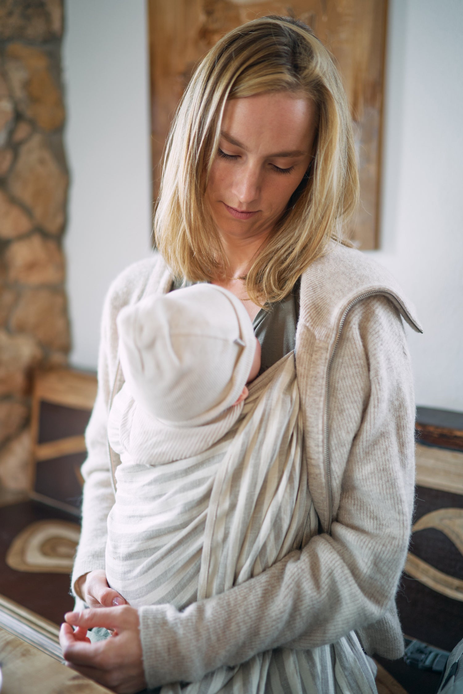 Mama trägt Baby in einer Ring Sling