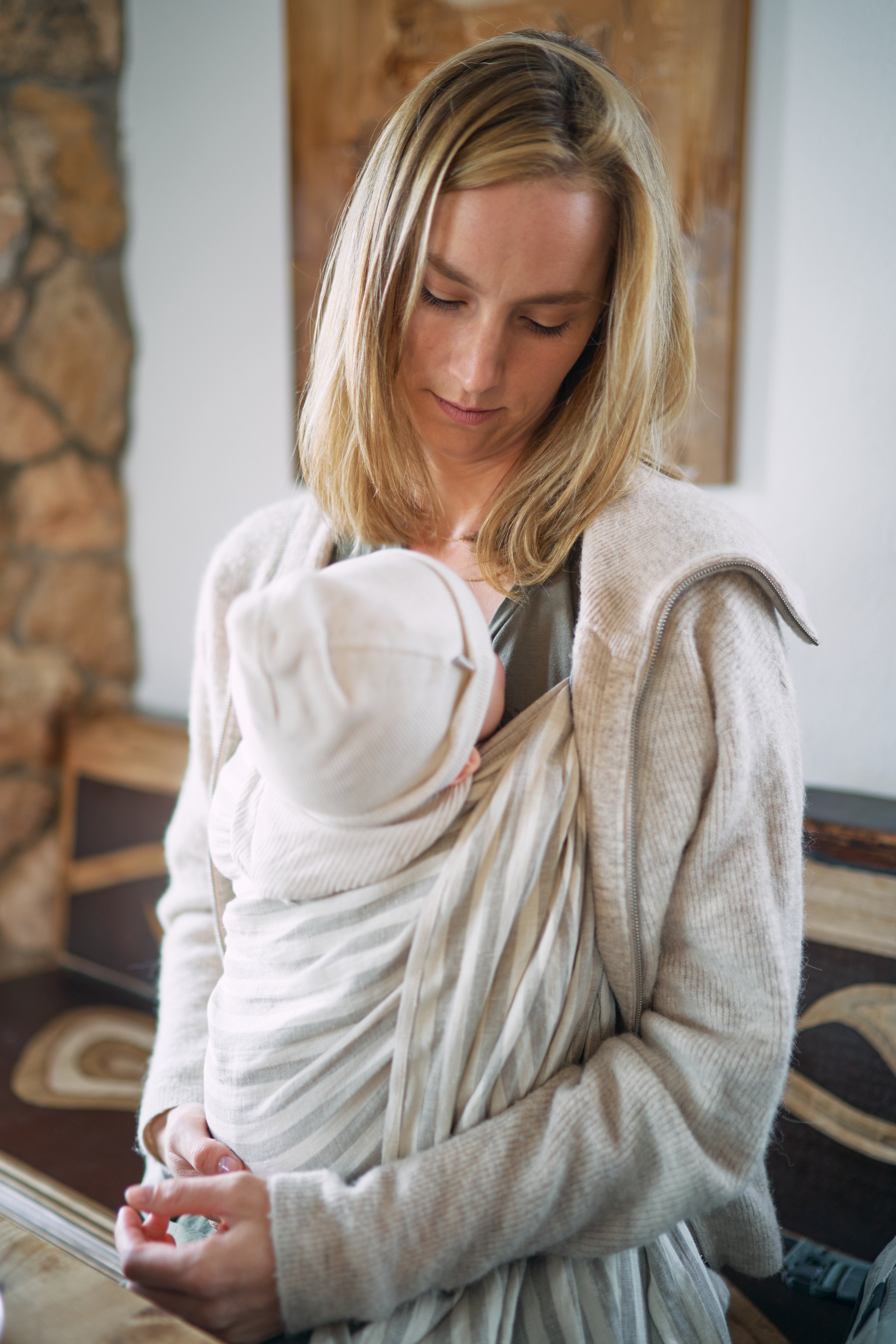 Mama trägt Baby in einer Ring Sling 